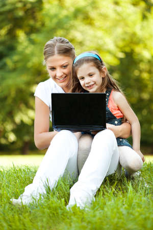 Mother and daughter having fun in parkの写真素材