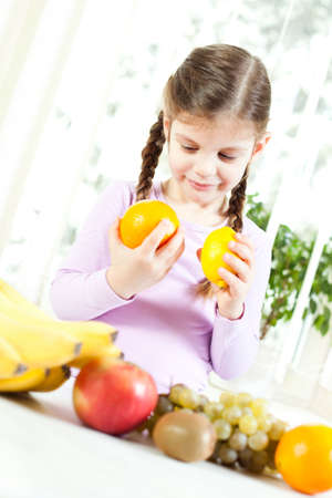 Happy child with fruitの写真素材