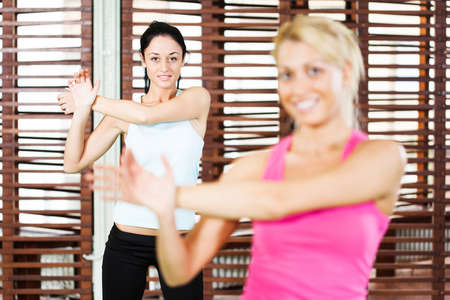 Young women stretching their bodies in gymの写真素材