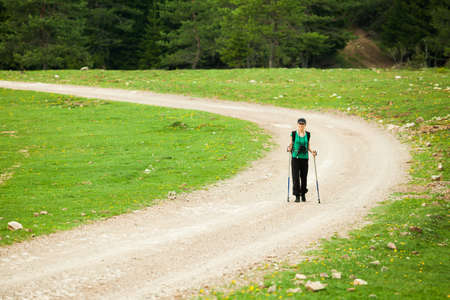 Hiker on road in forestの写真素材