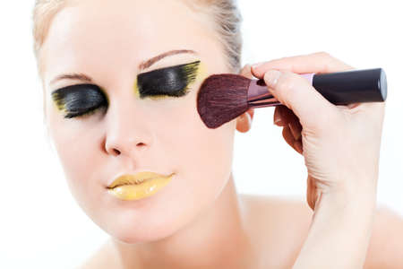 Beautician artist applying face powderの写真素材