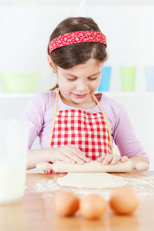 Little girl making the doughの写真素材