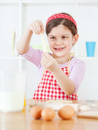 Little girl making the doughの写真素材