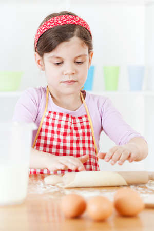 Little girl making the doughの写真素材