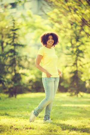 Young happy woman enjoying summertime intentionally tonedの写真素材