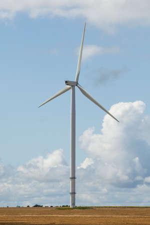 Wind turbine in the field and stormy skyの写真素材