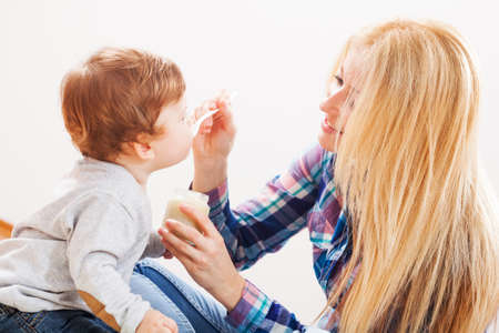 Mother feeding her baby boyの写真素材