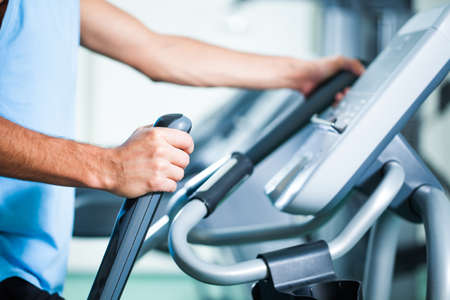 Man exercising on treadmill in gym