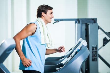 Happy man exercising in gymの写真素材