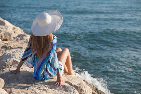 Young woman relaxing at seashoreの写真素材