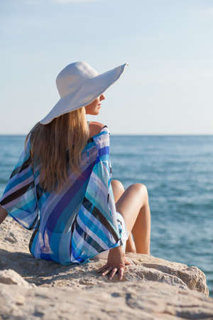 Young woman relaxing at seashoreの写真素材