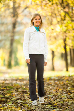 Young happy woman walking in parkの写真素材