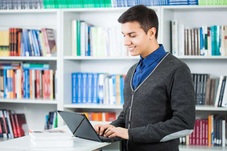 Happy student learning in libraryの写真素材