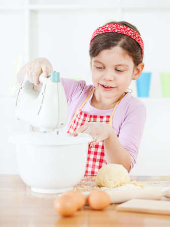 Little girl making the doughの写真素材