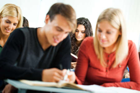 Group of university students learning in classroomの写真素材