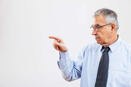 Portrait of senior businessman pointingの写真素材