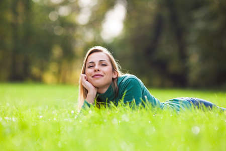 Happy woman relaxing and enjoying nature in parkの写真素材