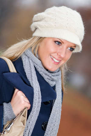 Portrait of young happy woman in park in wintertimeの写真素材