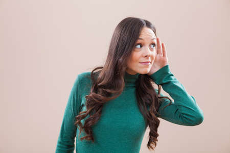 Portrait of woman who is eavesdroppingの写真素材