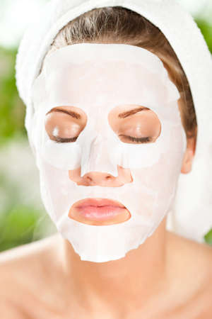 Young woman with skin mask on her faceの写真素材