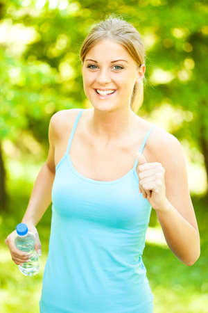 Young woman jogging in parkの写真素材