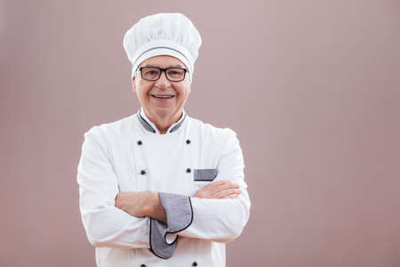 Portrait of happy restaurant's chef in working uniformの写真素材