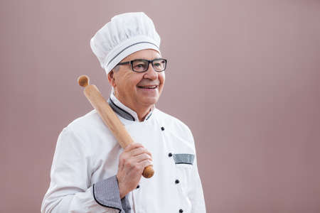 Portrait of happy restaurant's chef in working uniformの写真素材