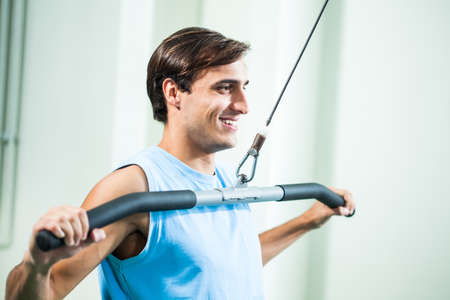 Young man exercising in gym.の写真素材