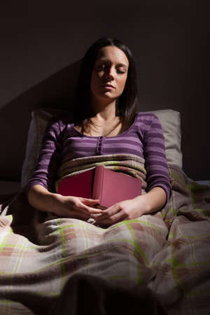 Young woman sleeping in her bed.の写真素材