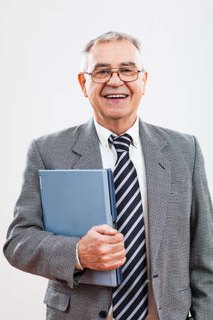 Portrait of successful senior businessman holding laptopの写真素材