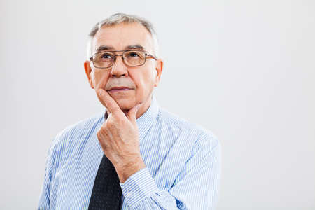 Portrait of pensive senior businessmanの写真素材