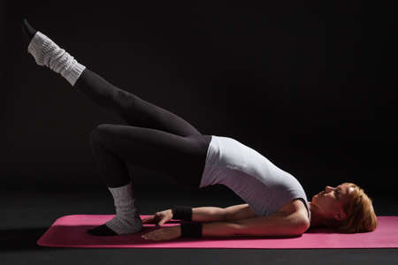 Young woman practicing yoga, Setuasana / Half Bridge poseの写真素材