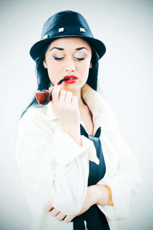 Studio shot portrait of girl with pipe, intentionally toned.の写真素材