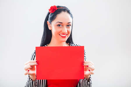 Woman holding red paper with blank space for text message.の写真素材