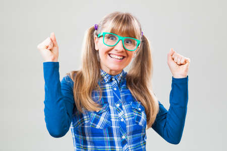 Studio shot portrait of cheerful nerdy womanの写真素材