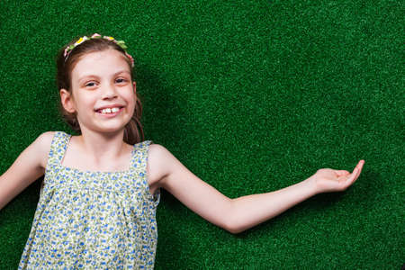 Happy little girl is holding your text or product.の写真素材