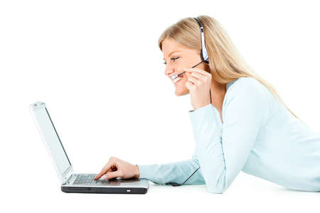 Young woman is using laptop. Isolated on white.の写真素材