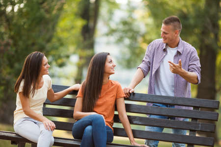Three friends are having time together in park.の写真素材