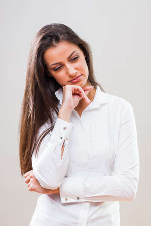 Studio shot portrait of pensive and worried businesswoman.の写真素材
