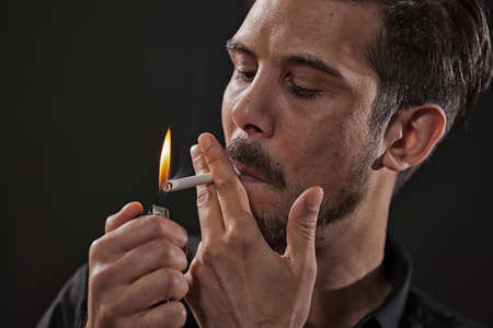 Portrait of adult man who is smoking cigarette.の写真素材