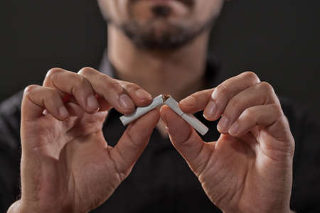 Close up image of adult man who is decided to quit smoking.の写真素材