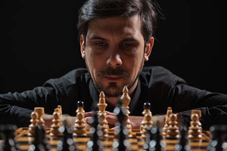 Portrait of adult man who is participating in chess game. Focus on man.の写真素材
