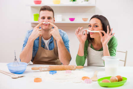 Young couple cooking in their kitchen.の写真素材