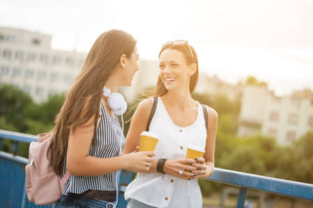 Two happy women are having fun together in the city in summer.の写真素材