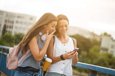 Two happy women are having fun together in the city.の写真素材