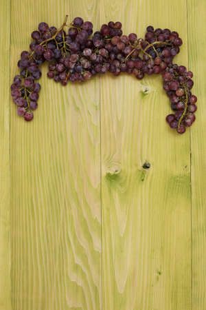 Close up of grape with blank space for text or advertisement. Rustic wooden background.の写真素材