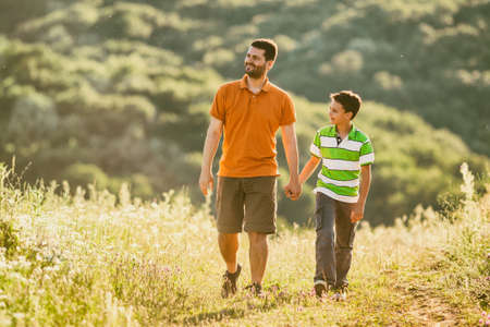 Father and son are walking in nature in summer.の写真素材