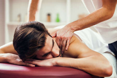 Young man is having massage on spa treatment.の写真素材