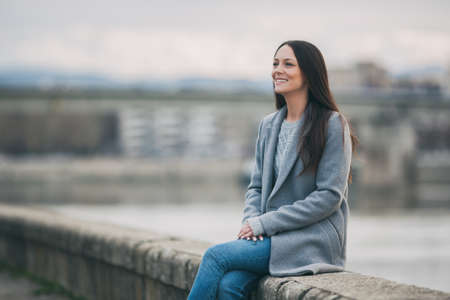 Young happy woman is relaxing outdoor after work.の写真素材