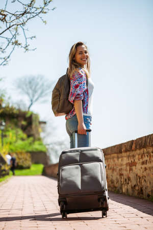 Happy mid adult woman is going on vacation.の写真素材